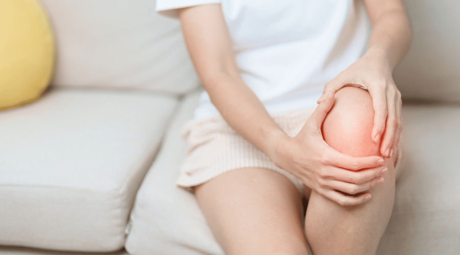 Woman having knee ache and muscle pain