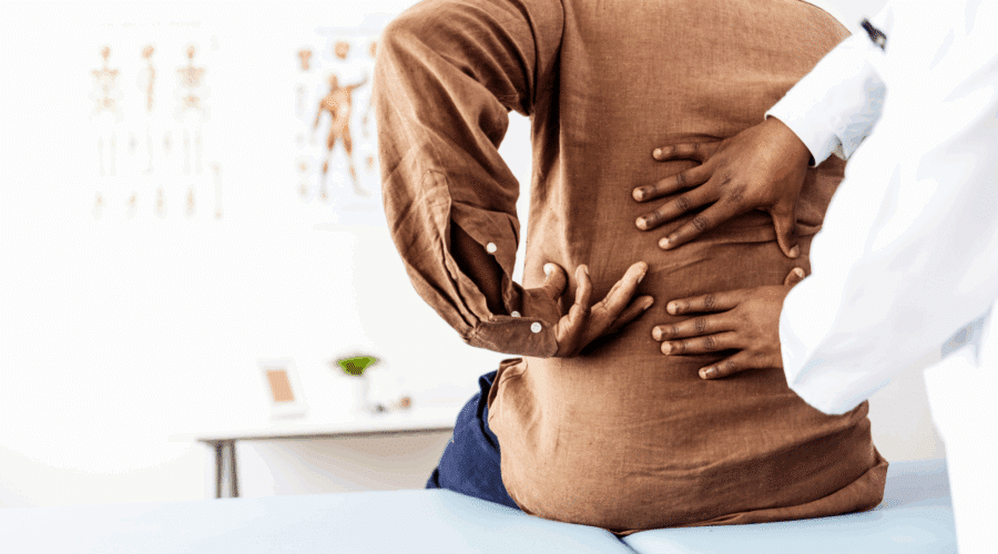 Doctor physiotherapist doing healing treatment on man's back