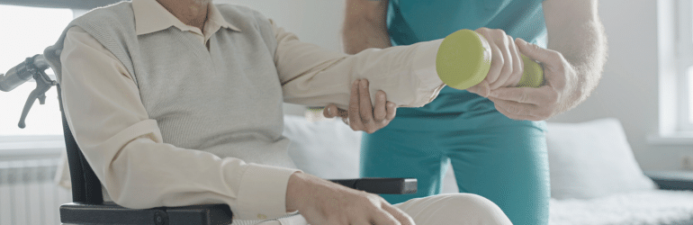 Man with disability doing exercise with assistance of physical therapist