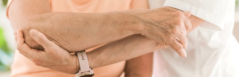 Physiotherapist working with elderly patient in clinic