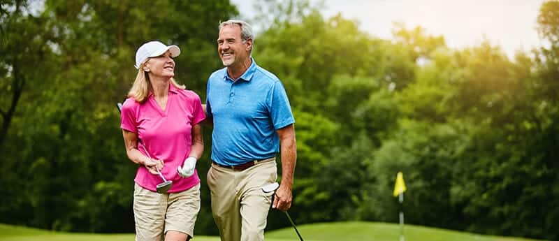 Man and woman enjoying golf fitness