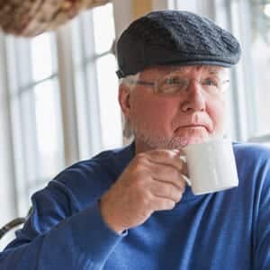 Man drinking coffee concerned about bladder health